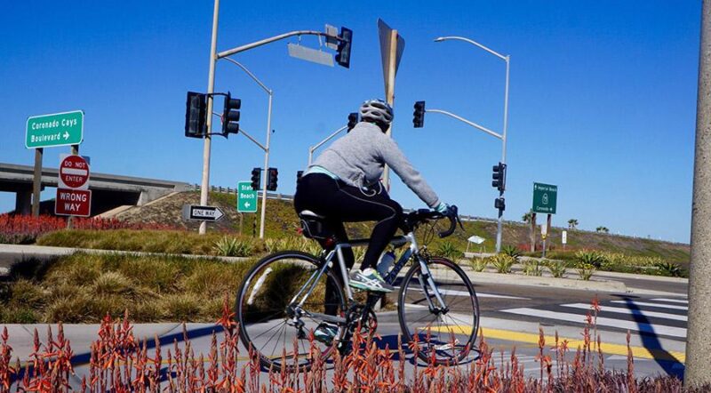 A Bayshore Bikeway cyclist navigates an intersection about 4.5 miles south of the City of Coronado, near the Silver Strand State Beach. The park features a long stretch of sandy beach along the Pacific coastline. | Photo by Cindy Barks
