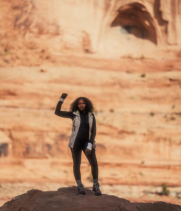 Debbie Njai standing with hand up - Photo courtesy Black People Who Hike