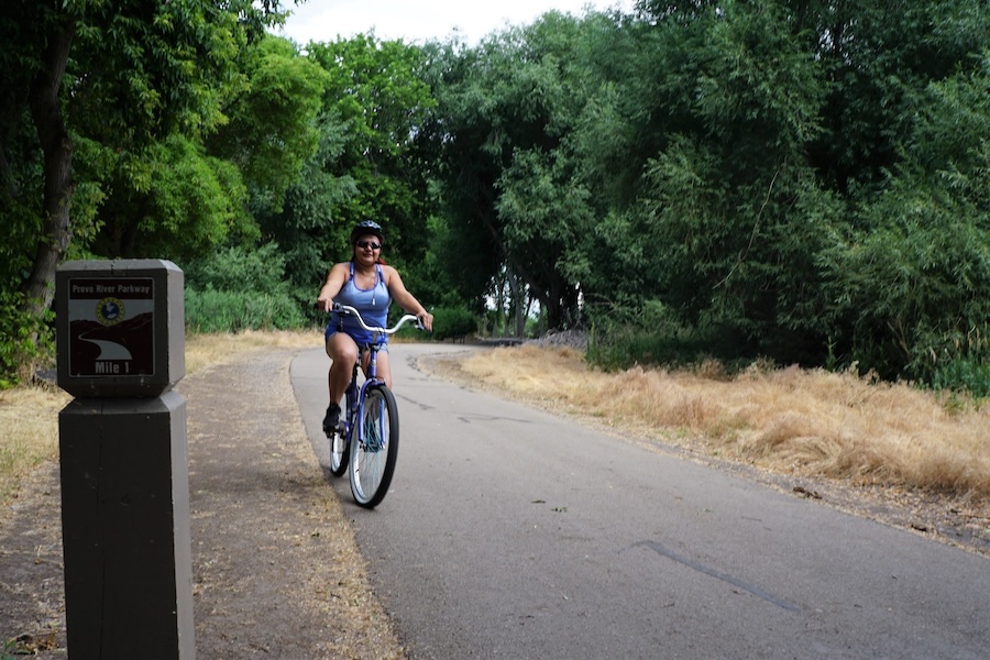 Provo, Utah, resident Veronica Hernandez takes a summer-morning ride along the Provo River Parkway. The 15.2-mile rail-trail is also popular with walkers and runners. | Photo by Cindy Barks