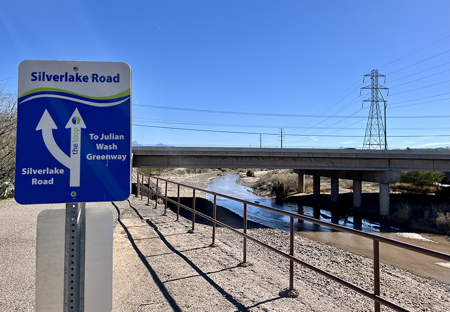 A stretch of the Santa Cruz River Park Trail at Silverlake Road in central Tucson borders the river, which was running with water in March. | Photo by Cindy Barks