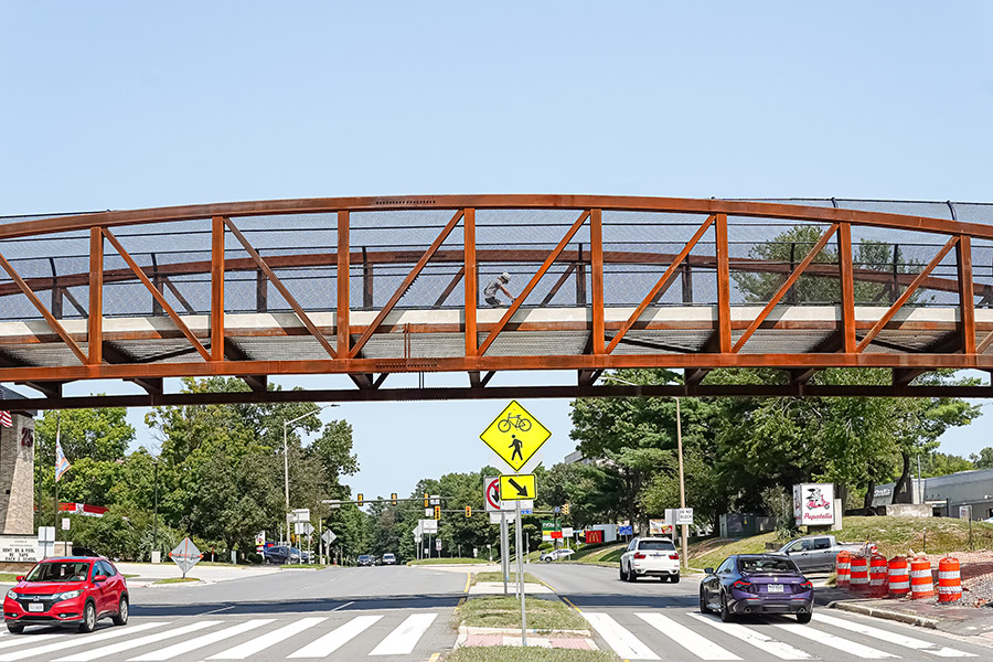 Opened in the summer of 2024, this 147-foot-long pedestrian bridge on the W&OD Trail provides safe crossings for people over busy Wiehle Avenue in Reston, Virginia. | Photo by Albert Ting