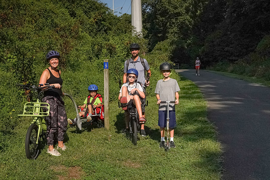 Rails to Trails Conservancy’s Vice President of Communications, Brandi Horton, with children Rex, Wayne and Jay, and husband Tommy, on the W&OD in Arlington, Virginia, in August 2024 | Photo by Albert Ting